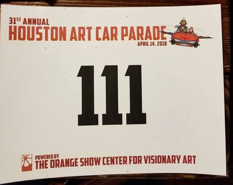 A parade participant number card for the 31st Annual Houston Art Car Parade, dated April 14, 2018, sponsored by The Orange Show Center for Visionary Art.